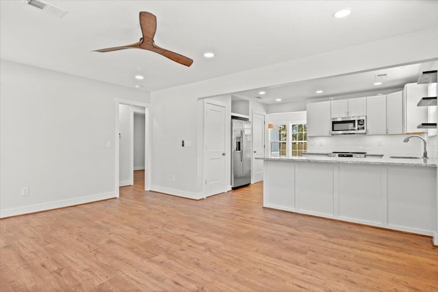 1430 E Montague Ave, North Charleston, SC 29405 - kitchen with stainless steel appliances, a sink, recessed lighting, light wood finished floors, and a peninsula