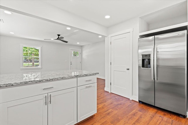 1430 E Montague Ave, North Charleston, SC 29405 - kitchen with stainless steel refrigerator with ice dispenser, light wood finished floors, light stone countertops, recessed lighting, and a ceiling fan