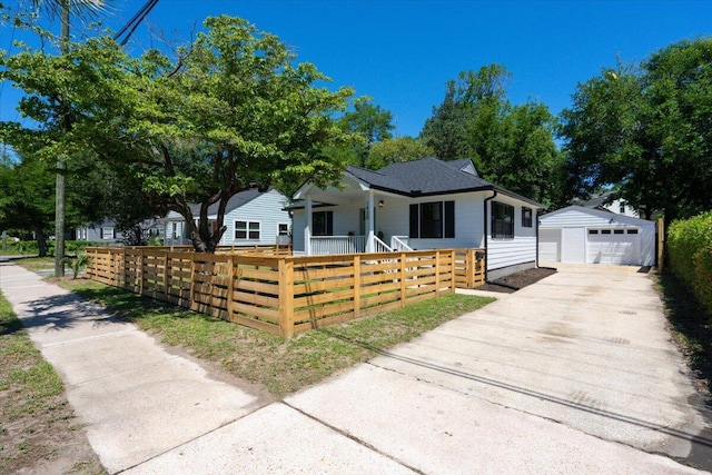 1430 E Montague Ave, North Charleston, SC 29405 - view of front of house featuring a fenced front yard, driveway, a detached garage, an outdoor structure, and covered porch