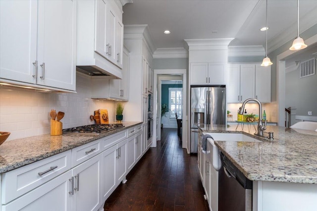 kitchen with light stone counters, decorative light fixtures, appliances with stainless steel finishes, ornamental molding, and white cabinetry