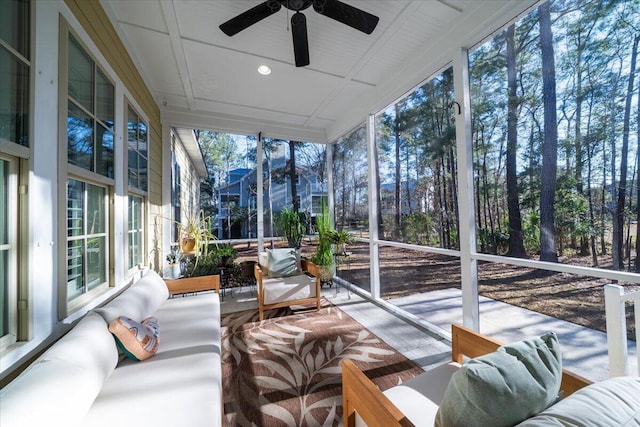 sunroom / solarium featuring ceiling fan