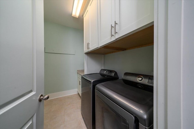 laundry area with cabinet space, washer and clothes dryer, and baseboards