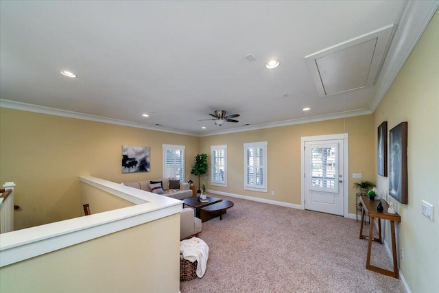 living room with light carpet, attic access, ornamental molding, and baseboards