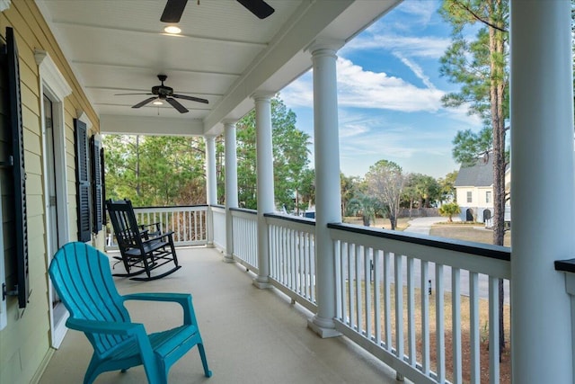 balcony featuring a porch, a sunroom, and ceiling fan