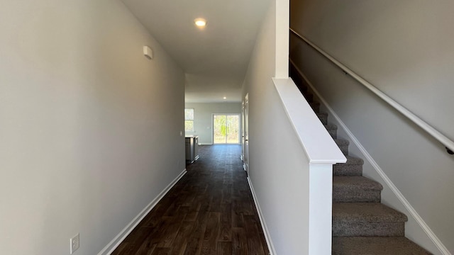 interior space with dark wood-style floors, recessed lighting, stairs, and baseboards