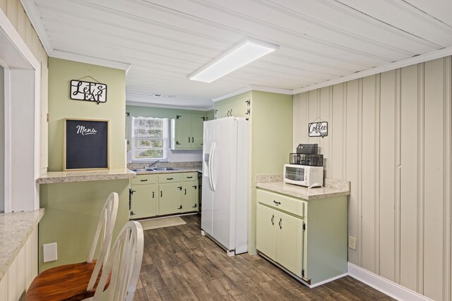kitchen with white appliances, green cabinets, dark wood finished floors, light countertops, and crown molding