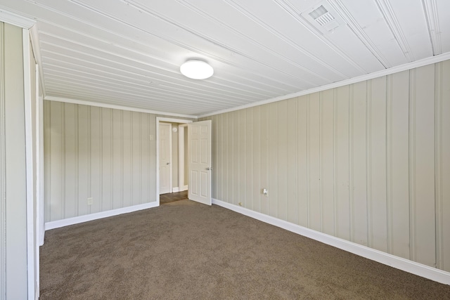 unfurnished room with dark carpet and baseboards