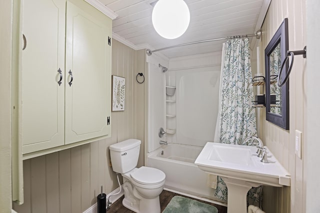 bathroom with toilet, shower / bath combo, and a sink