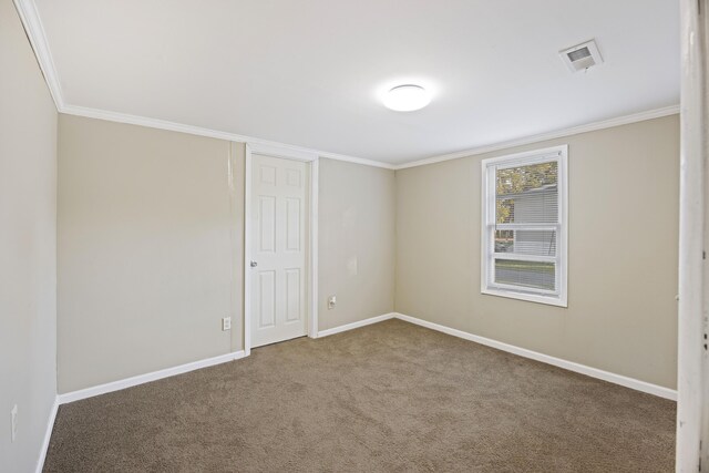 unfurnished room with ornamental molding, baseboards, and carpet