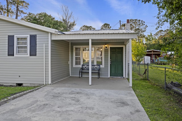 entrance to property featuring a porch and a chimney