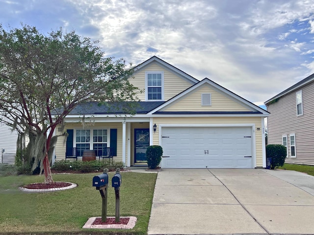 view of front of property featuring a porch, a front yard, and a garage