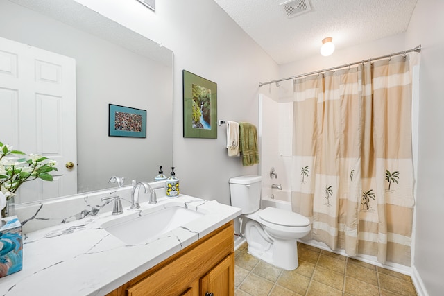 full bathroom featuring shower / bath combo, vanity, a textured ceiling, tile patterned flooring, and toilet