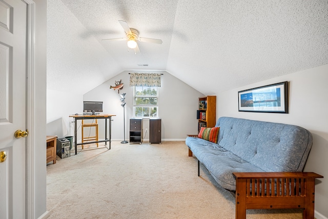 sitting room featuring carpet, ceiling fan, a textured ceiling, and vaulted ceiling