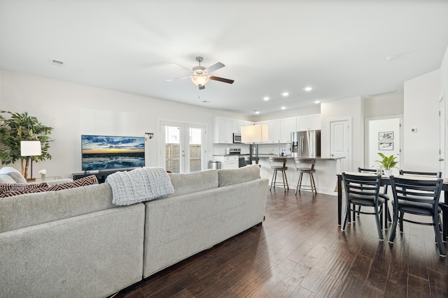 living room with ceiling fan, french doors, and dark wood-type flooring