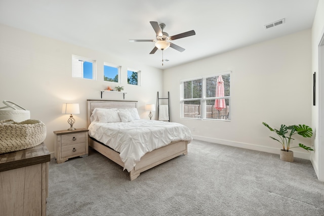 bedroom with ceiling fan and light colored carpet