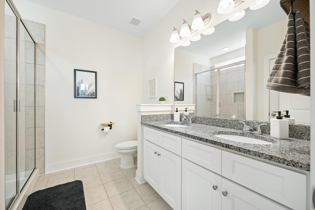 bathroom with toilet, vanity, an enclosed shower, and tile patterned floors