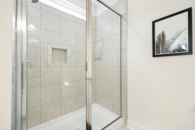 bathroom with a shower with shower door