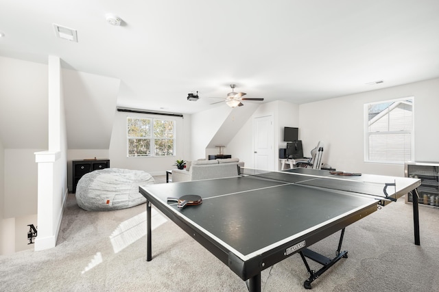 rec room featuring light carpet, ceiling fan, and vaulted ceiling