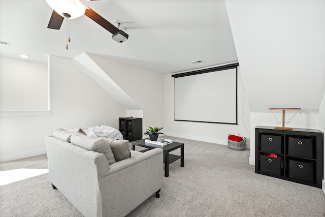 home theater featuring ceiling fan and light colored carpet