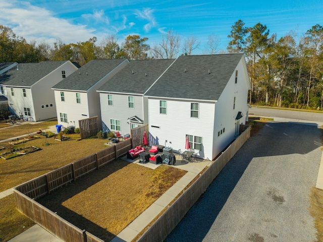 rear view of house featuring a patio area and a yard