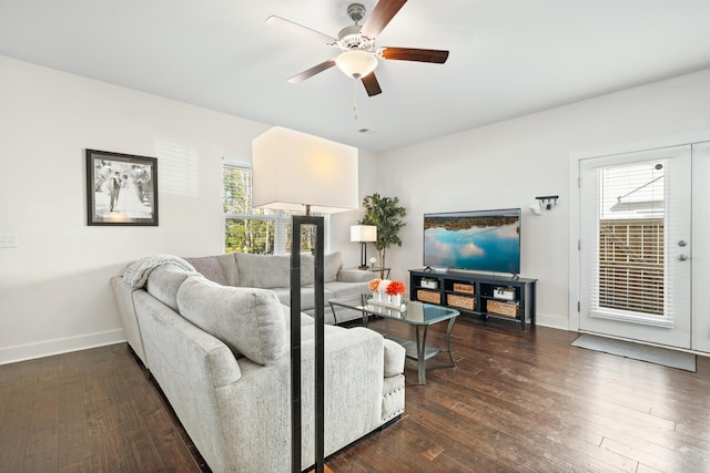 living room featuring ceiling fan and dark hardwood / wood-style floors