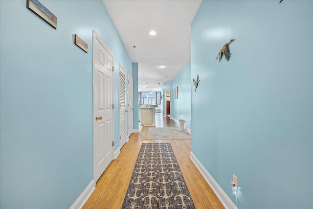 216 W Arctic Ave Unit 9, Folly Beach, SC 29439 - hallway with light wood finished floors, baseboards, and recessed lighting