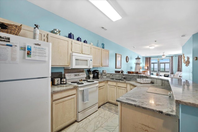 216 W Arctic Ave Unit 9, Folly Beach, SC 29439 - kitchen with white appliances, a sink, a peninsula, light marble finish floors, and light brown cabinets