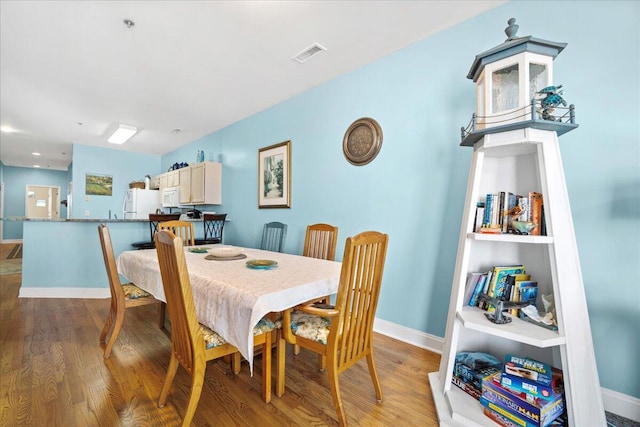 216 W Arctic Ave Unit 9, Folly Beach, SC 29439 - dining area with light wood-style floors and baseboards