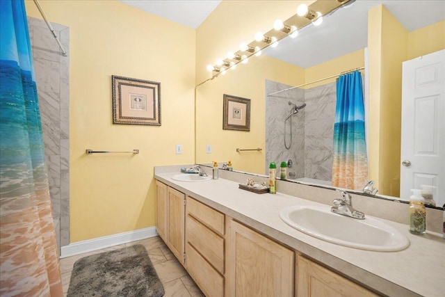 216 W Arctic Ave Unit 9, Folly Beach, SC 29439 - bathroom with marble finish floors, baseboards, and double vanity