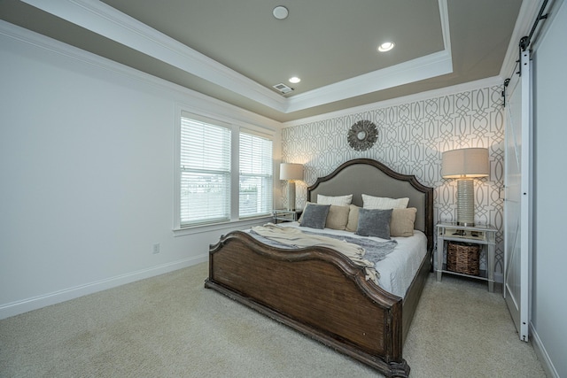 carpeted bedroom with wallpapered walls, crown molding, baseboards, a barn door, and a raised ceiling