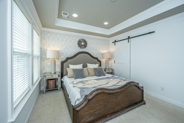 carpeted bedroom with baseboards, visible vents, wallpapered walls, ornamental molding, and a barn door