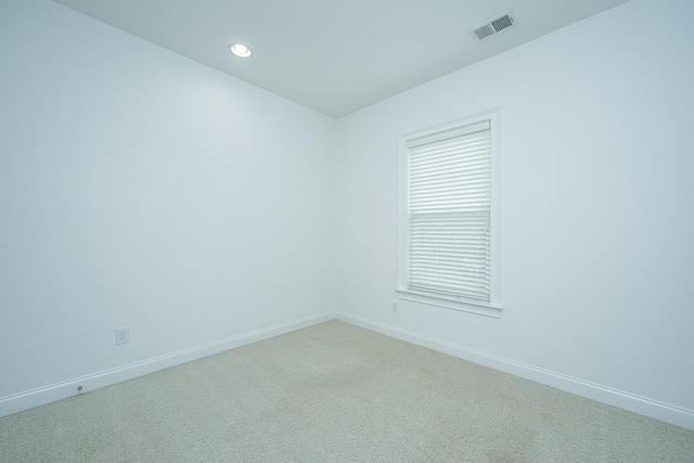 spare room featuring recessed lighting, visible vents, carpet floors, and baseboards