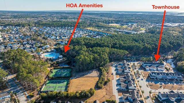 aerial view featuring a wooded view and a residential view