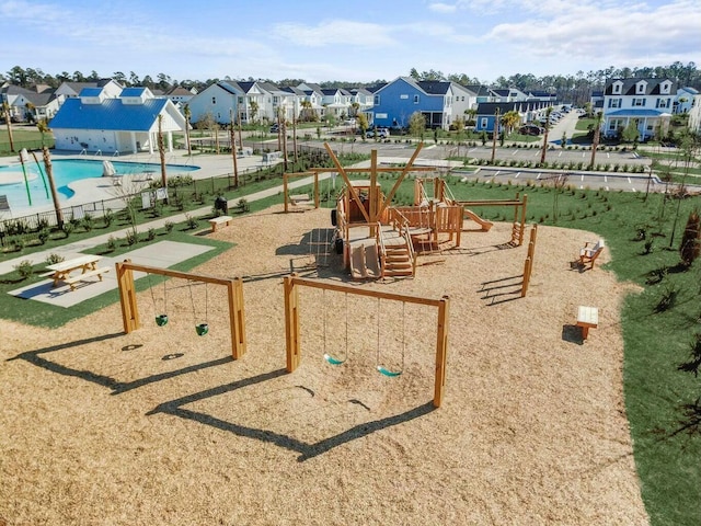 community jungle gym featuring a residential view and fence