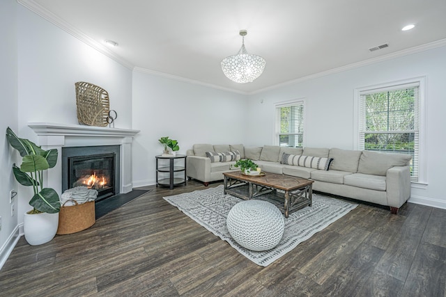 living room featuring a glass covered fireplace, crown molding, baseboards, and wood finished floors