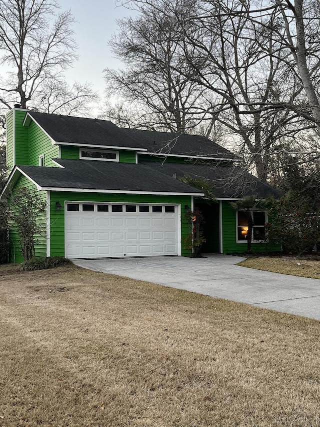 view of front of home featuring a chimney, a front lawn, concrete driveway, and a garage