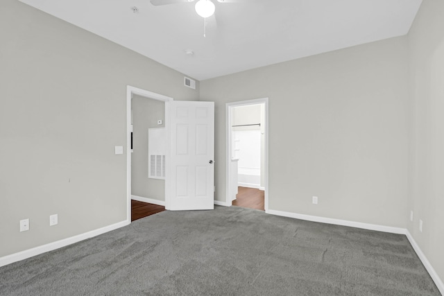 unfurnished bedroom featuring dark carpet and ceiling fan