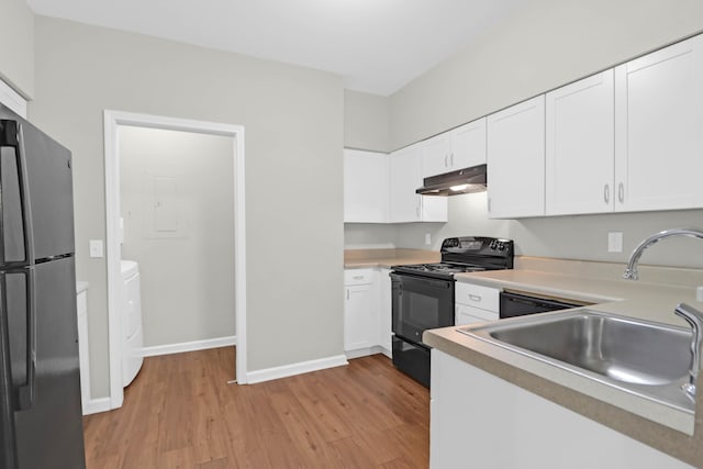 kitchen featuring white cabinetry, black electric range, and stainless steel fridge