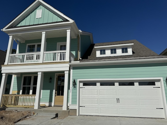 view of front of house featuring a balcony, a garage, and covered porch