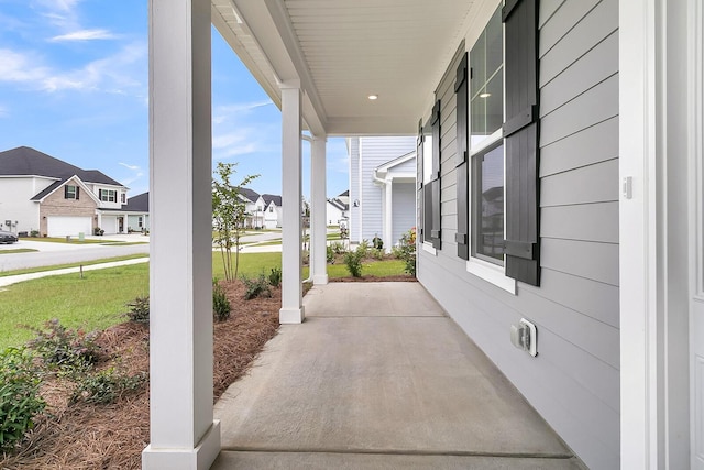 view of patio with covered porch and a residential view