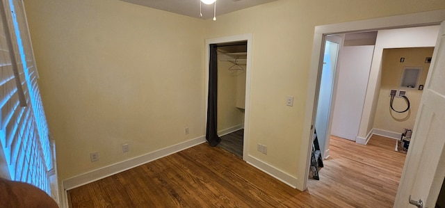 unfurnished bedroom with light hardwood / wood-style floors and a closet