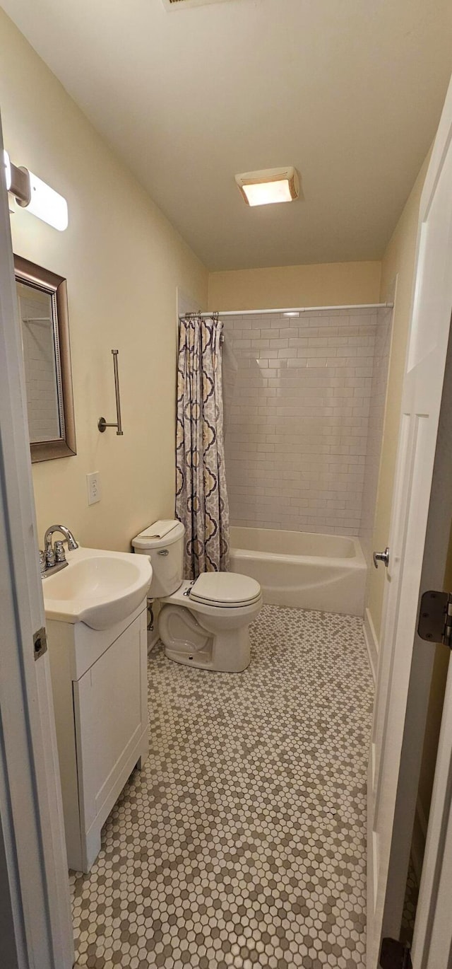 full bathroom with vanity, shower / bath combination with curtain, and toilet