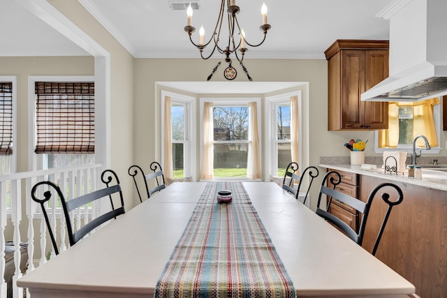 dining room featuring a chandelier and crown molding