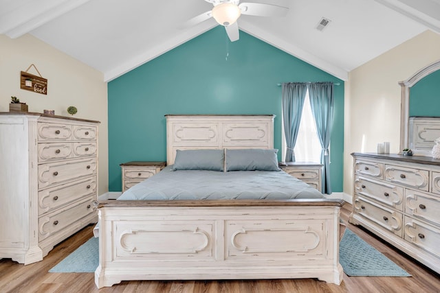 bedroom featuring ceiling fan, light hardwood / wood-style floors, and lofted ceiling with beams