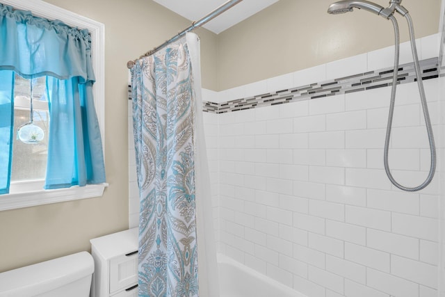 bathroom featuring toilet and shower / tub combo with curtain