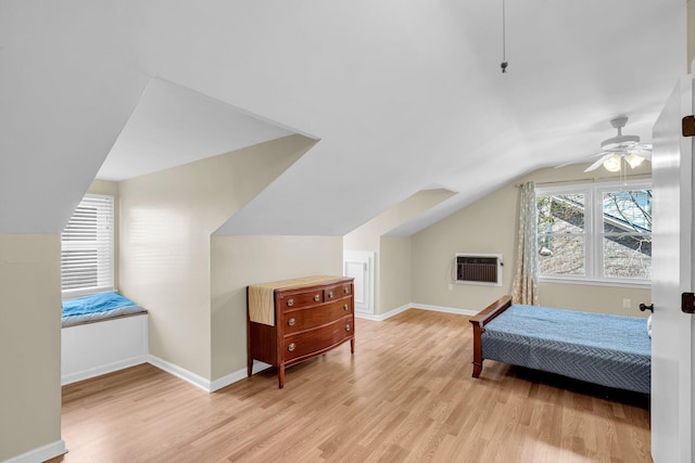 bedroom with ceiling fan, lofted ceiling, and light hardwood / wood-style floors