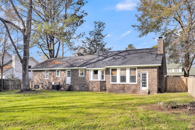 back of house featuring central air condition unit and a lawn