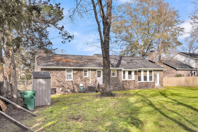 back of property with a lawn and central AC unit