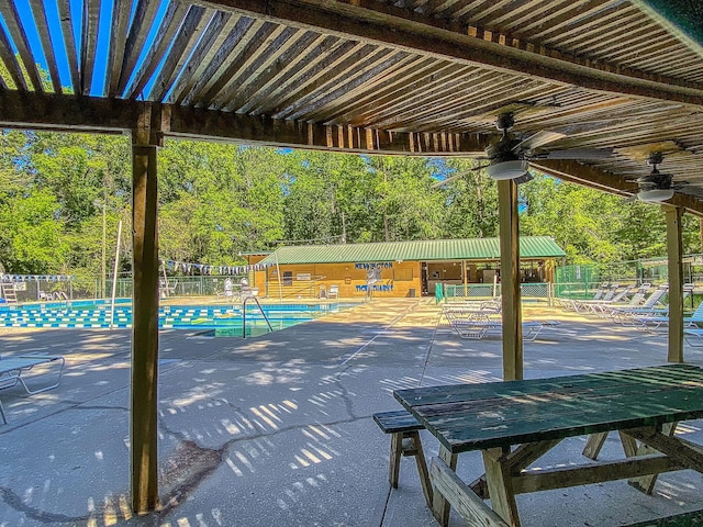 view of patio with ceiling fan and a community pool