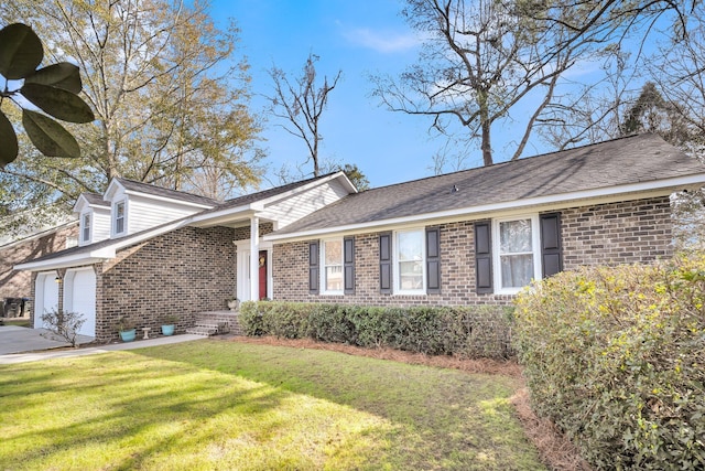 ranch-style house with a garage and a front lawn